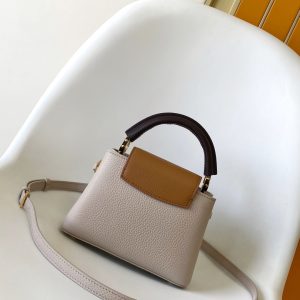 Alternative view of p105031.05 x 20.0 x 11.0 cm (L x H x W) 27.0 x 17.3 x 9.0 cm (L x H x W) 21.0 x 13.6 x 8.0 cm (L x H x W) • Taurillon calf leather • Calf leather trim •Cowhide leather lining•Metal hardware•Flap can be positioned inside or outside•Zippered interior pocket•Interior patch pocket•Metal studs•Holds smartphone, LV Vertical wallet, headphones, and keys•Strap: Detachable, adjustable•Strap half-length: 45.5 cm•Strap half-length adjustable to: 53.0 cm•Handle: Single handle